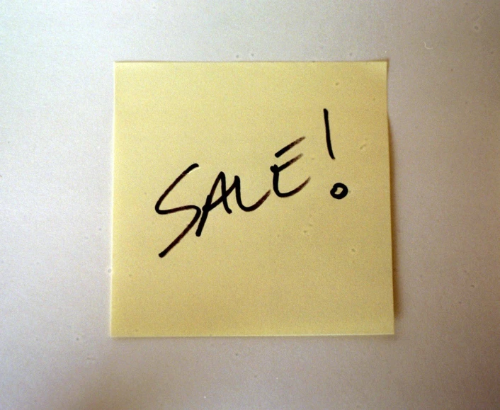 a note that reads sale with some black ink