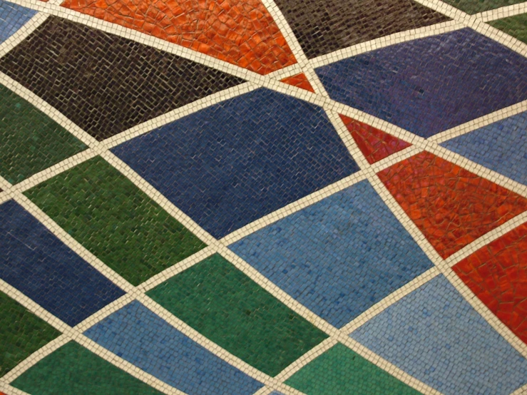 a close up of many colored tiles on the floor