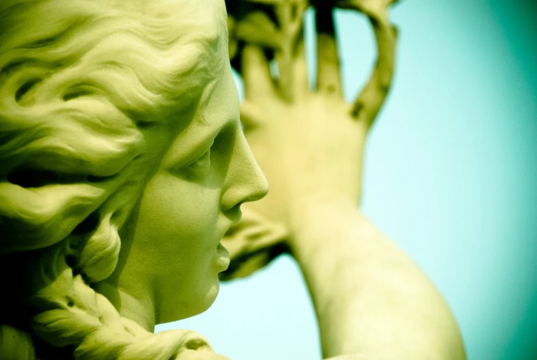 the back and side view of a statue of two girls looking at each other