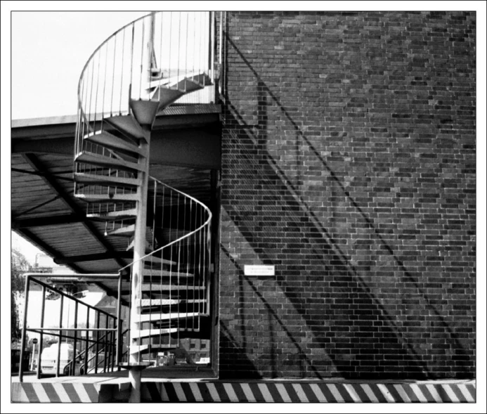 a spiral staircase in the middle of a brick building