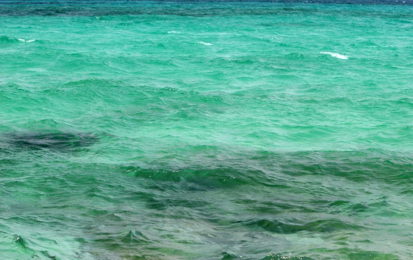 some very pretty green and blue water by the beach