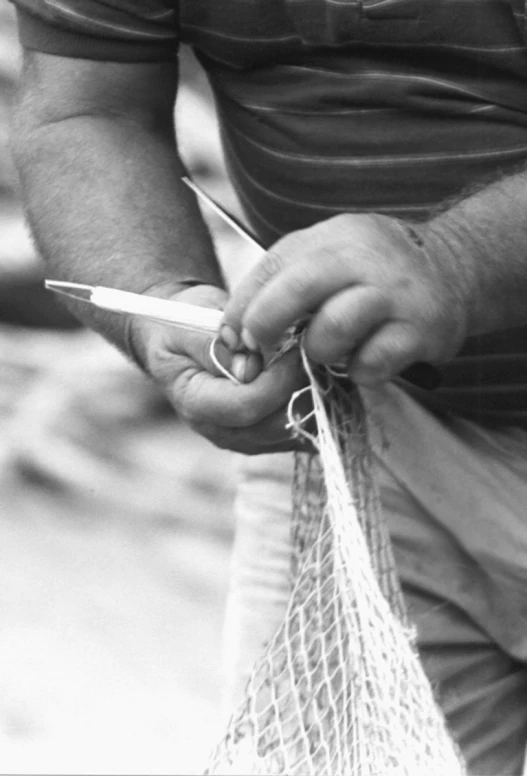 a man holding a bag and scissors in one hand