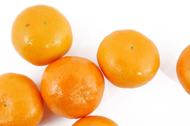 five oranges, with one in the middle on top