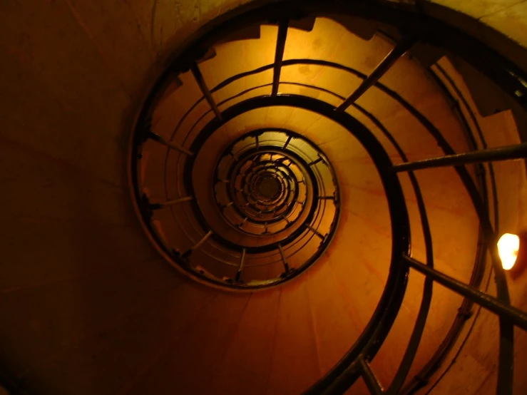 a spiral staircase inside a building with light bulb