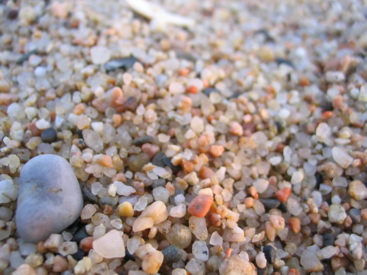 some small rocks and gravel on top of the ground