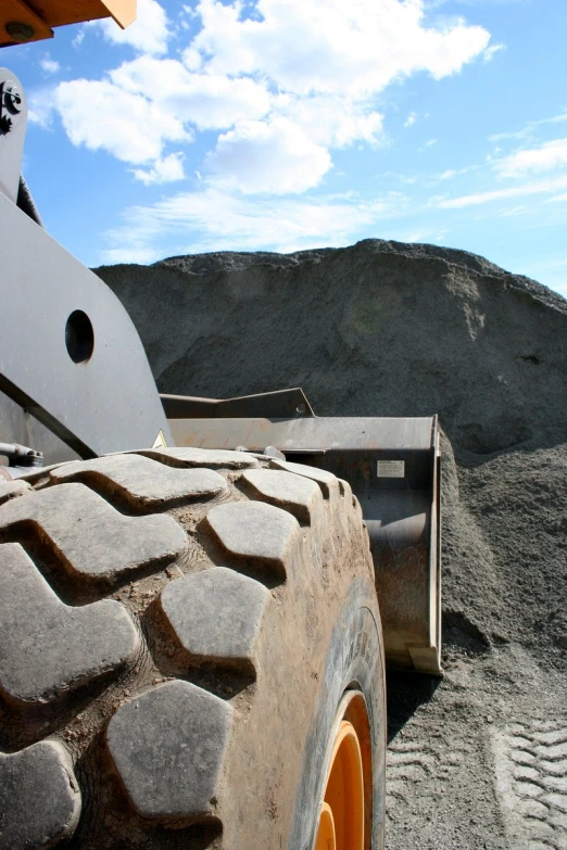 a large wheel sitting in front of a large mountain