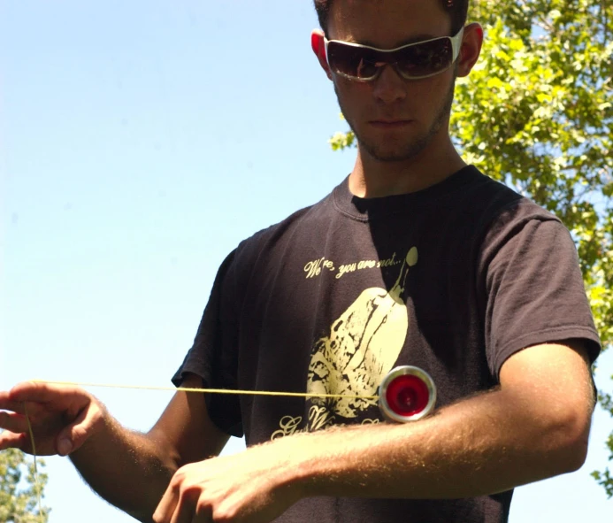 a man holds soing in his hand and points it towards the other