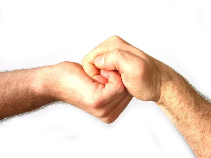 two people with hands held together with their fists