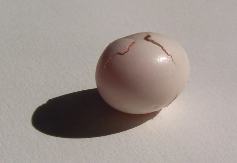 a white ball with a ed top on a table