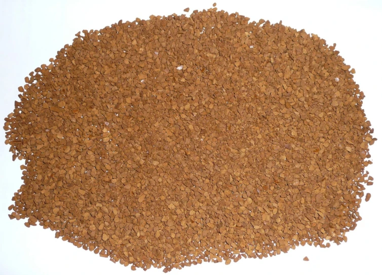 ground meat and grain is on a white surface