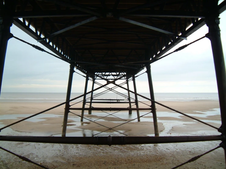 view of a structure from the back side of the structure on a beach