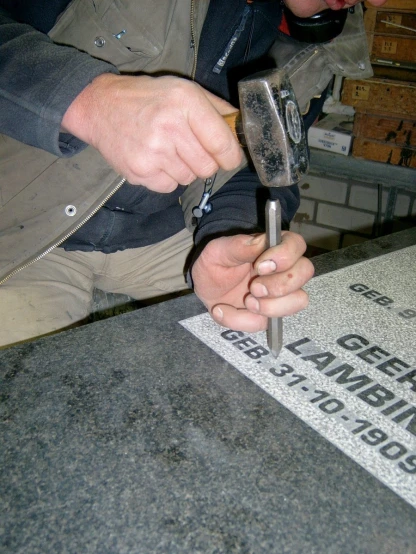 a man is using a large drill tool on a piece of wood