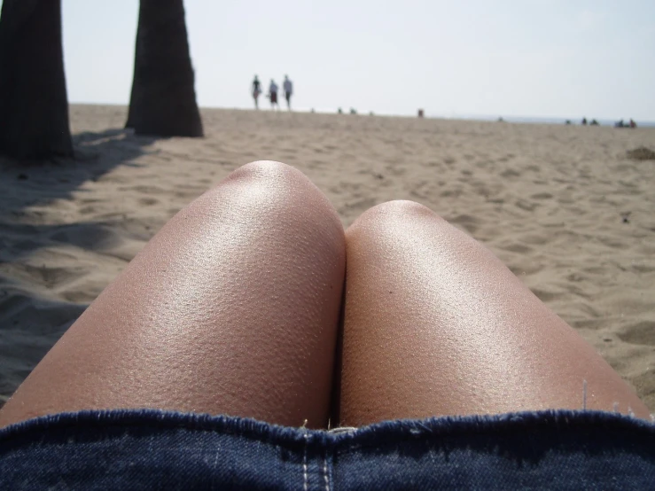 a close up s of some people standing in the sand on the beach