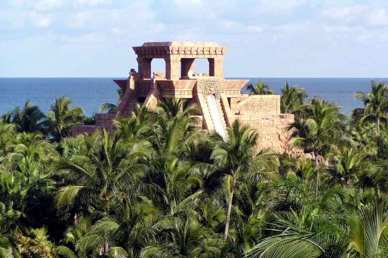 a large building is on a cliff overlooking the ocean