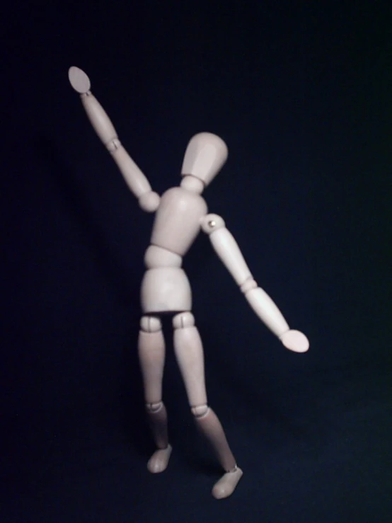 a white male doll poses with one arm in the air