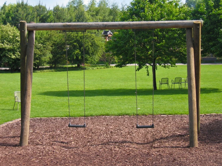 a wooden swing set with a swing and swings on it