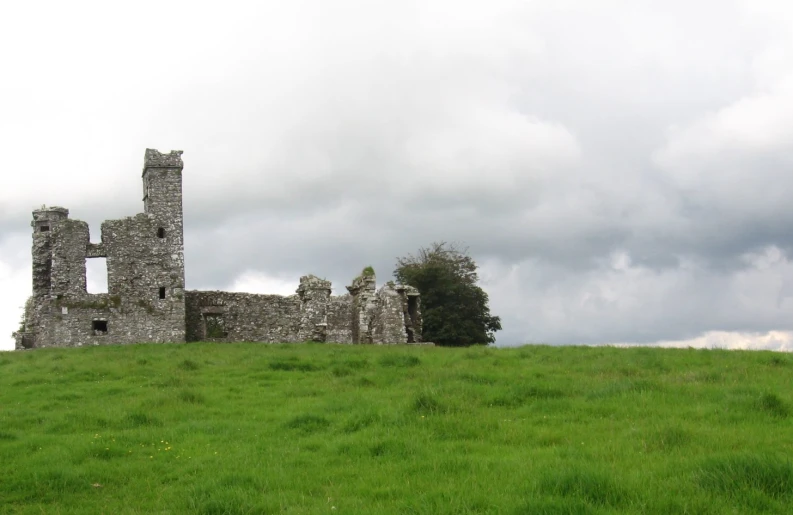 the clouds move in the distance as the castle looks over the grass