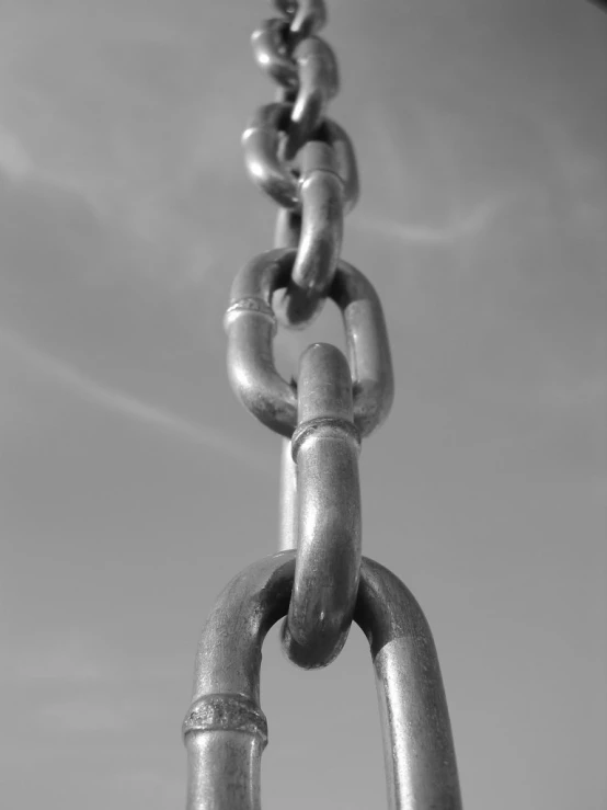 a very large chain attached to a metal fence