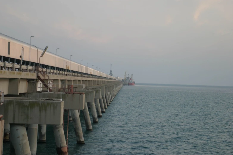 a view of a boat in the water from a pier