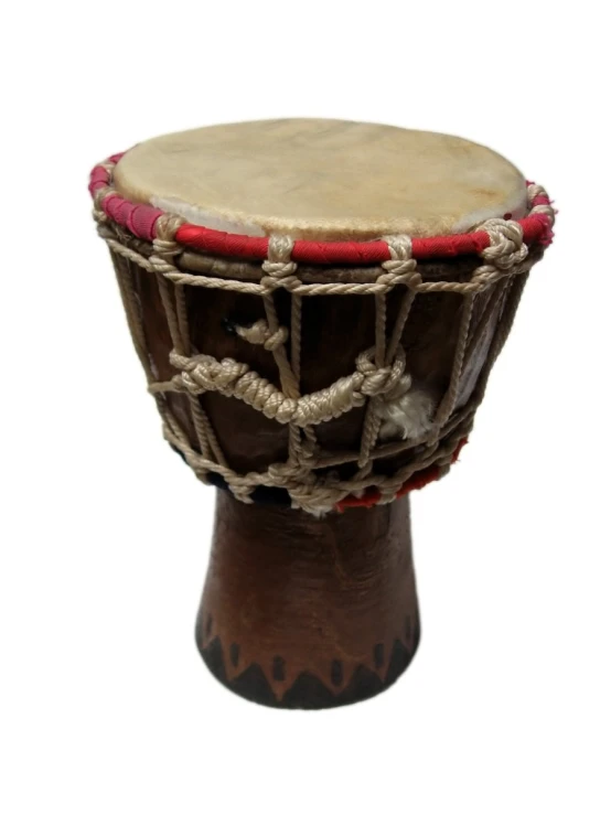 an african drum sitting on top of a wooden stand