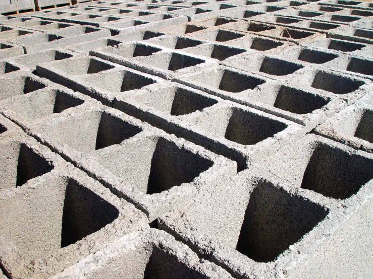 a closeup image of square holes in concrete