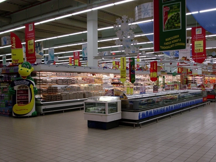 an empty supermarket aisle with several signs in it