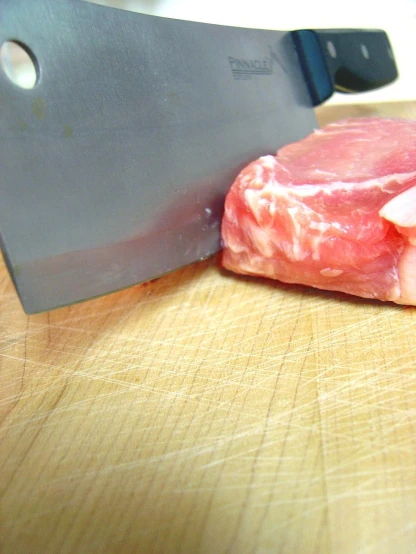 a raw steak is being cut into thin pieces
