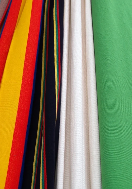 rainbow colored striped sheets piled on top of each other