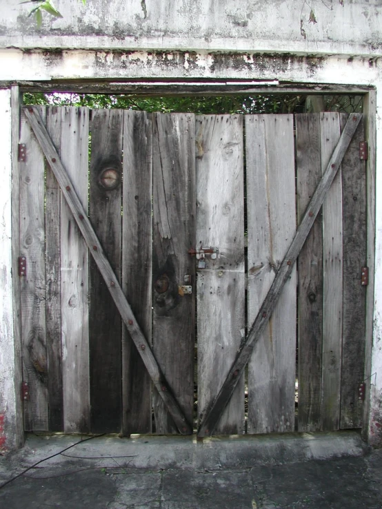 a weathered wood door with wooden planks