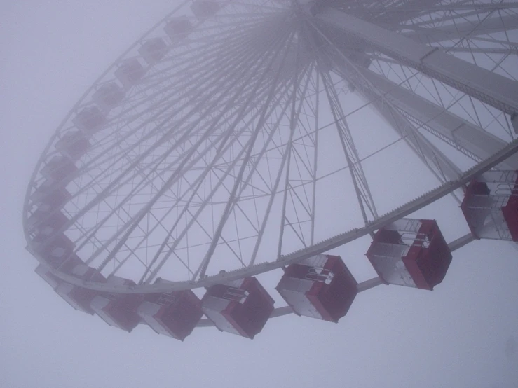 a ferris wheel with red and white wooden seats