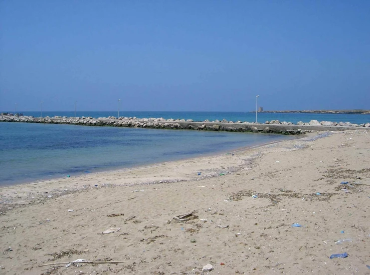 there is a beach with plastic bottles and garbage everywhere