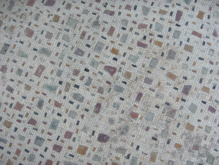 closeup po of an upholstered rug with different colors and shapes