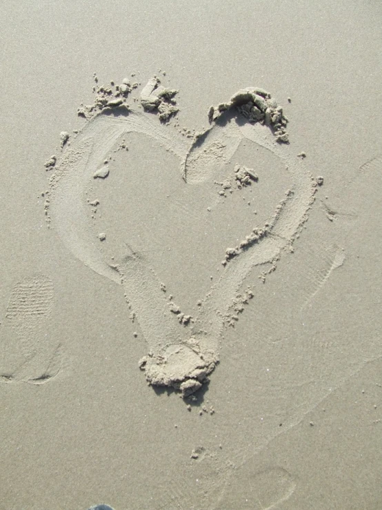 there is a small heart drawn on the beach