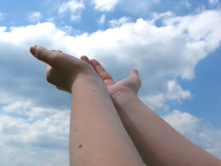 two people who are holding hands in the sky