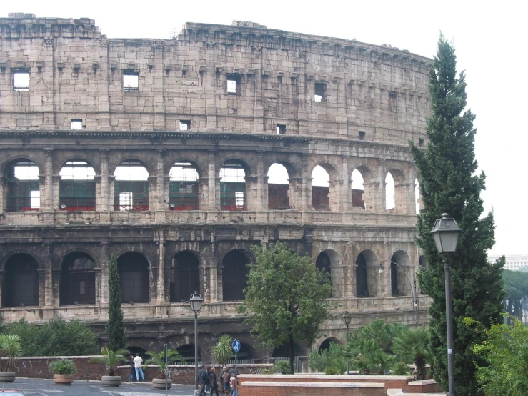 tourists stand next to an ancient roman theatre