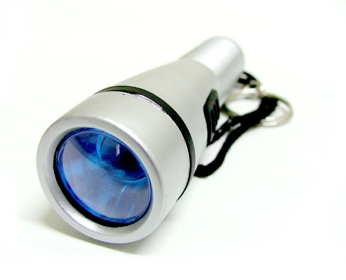 a blue flashlight is sitting on a white table