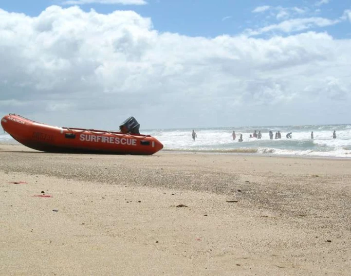 the people are riding in an orange boat