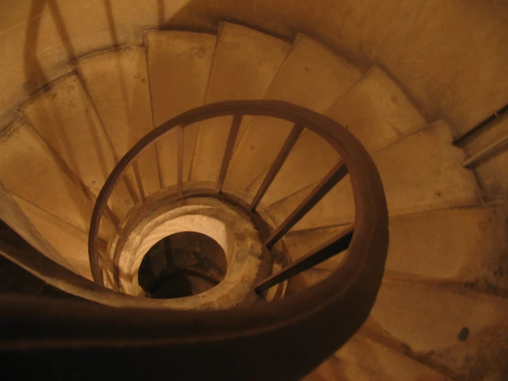view down spiral staircase with the view to a light