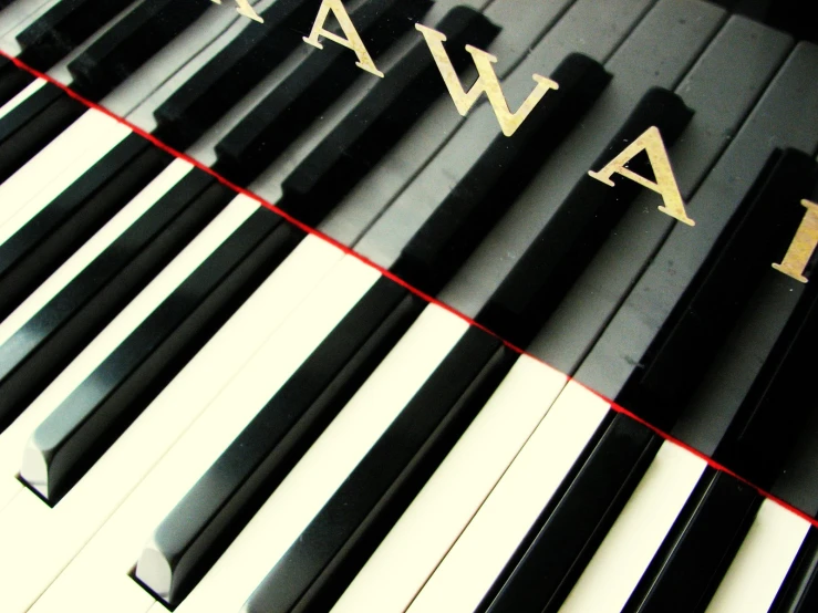 a piano with gold letters on it and an arrangement of black and white piano keys