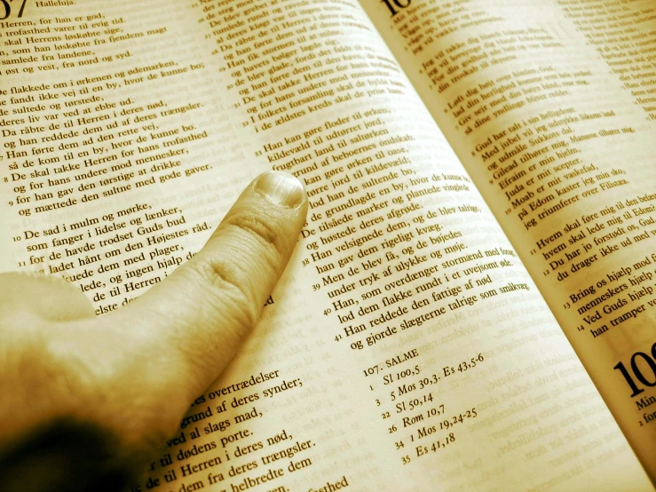 the index finger on top of a book in thai