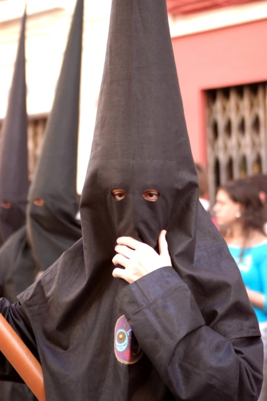 a person wearing a black outfit with lots of hoods