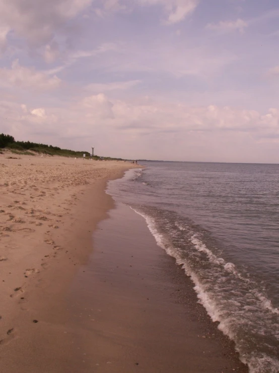 the sandy beach has footprints in it