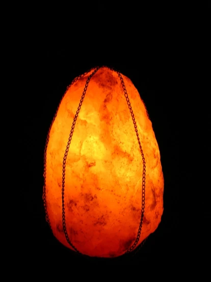 a large orange light bulb in the dark