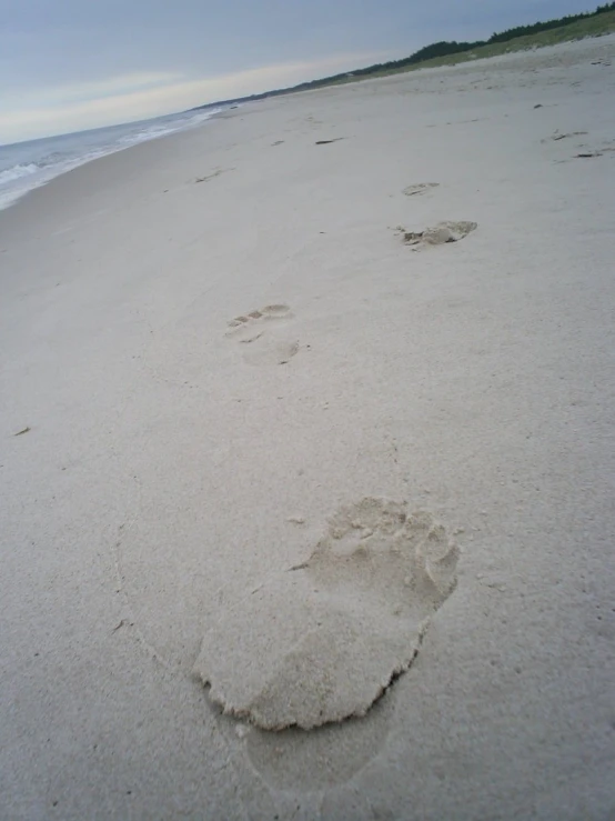 footprints drawn in the sand at the beach