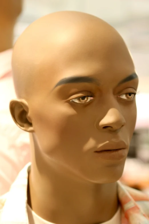 an afro male mannequins head wearing white collar shirts