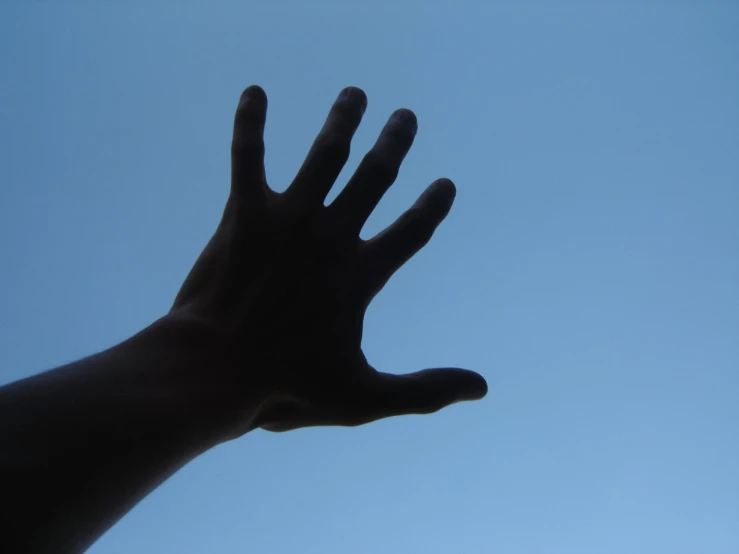 a hand that is reaching up into the sky