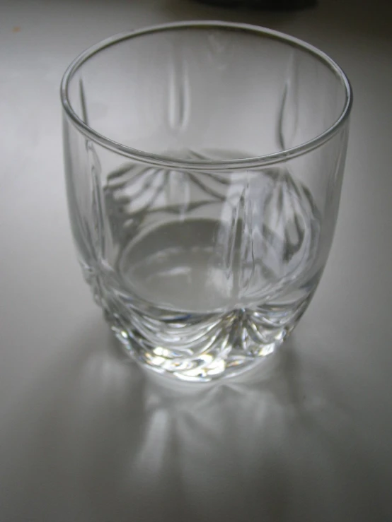 glass with liquid sitting on table with white background