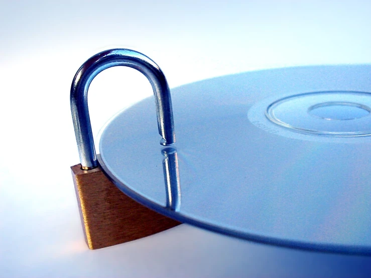 a metal lock on top of a blue disc