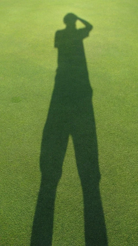 a shadow of a man wearing a hat