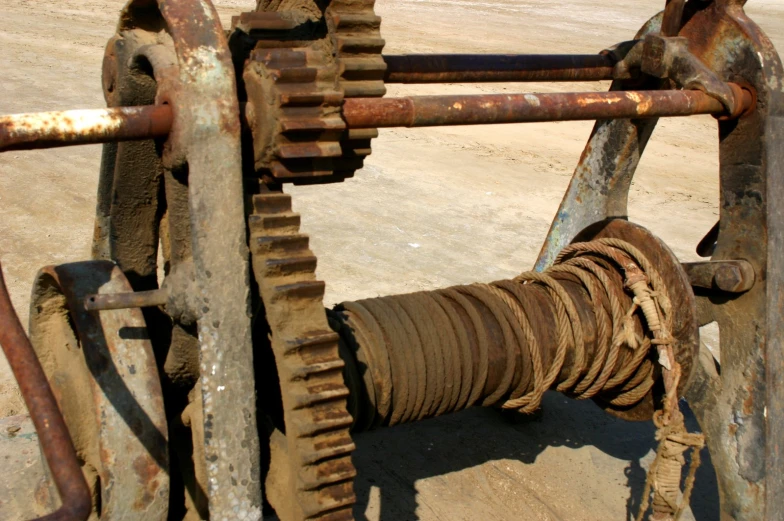 an industrial style machine with multiple gears is sitting outdoors